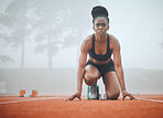 Woman, runner and race track in start position for marathon practice, speed test or fast cardio. Black person, athlete and misty morning for sports performance or workout growth, fitness for training