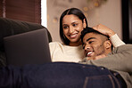 Love, hug and couple with laptop on sofa relax with social media, movies or streaming film at home together. Happy, smile and people in living room with show, video or bond in a house for staycation