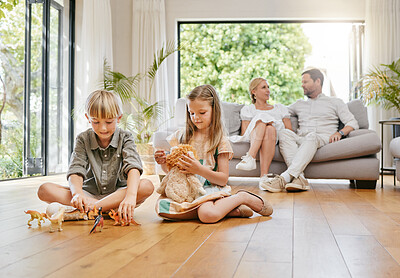 Buy stock photo Brother, sister and playing with toys on floor with parents relax at home for bonding and care. Boy, girl and children play with objects for development and growth in the living room of the house