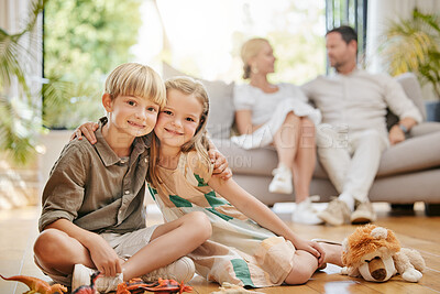 Buy stock photo Smile, love and portrait of children on the floor of the living room playing with toys together. Happy, playful and cute boy and girl kid siblings hugging and bonding in the lounge of family home.