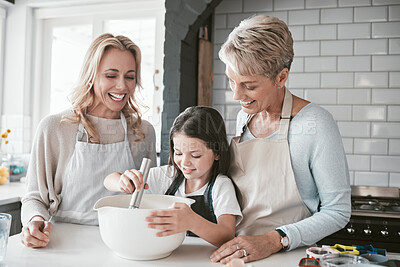 Buy stock photo Family, children and baking with a mother, grandmother and girl in the kitchen of their home together. Food, kids and bake with a woman, parent and female child learning about cooking while bonding