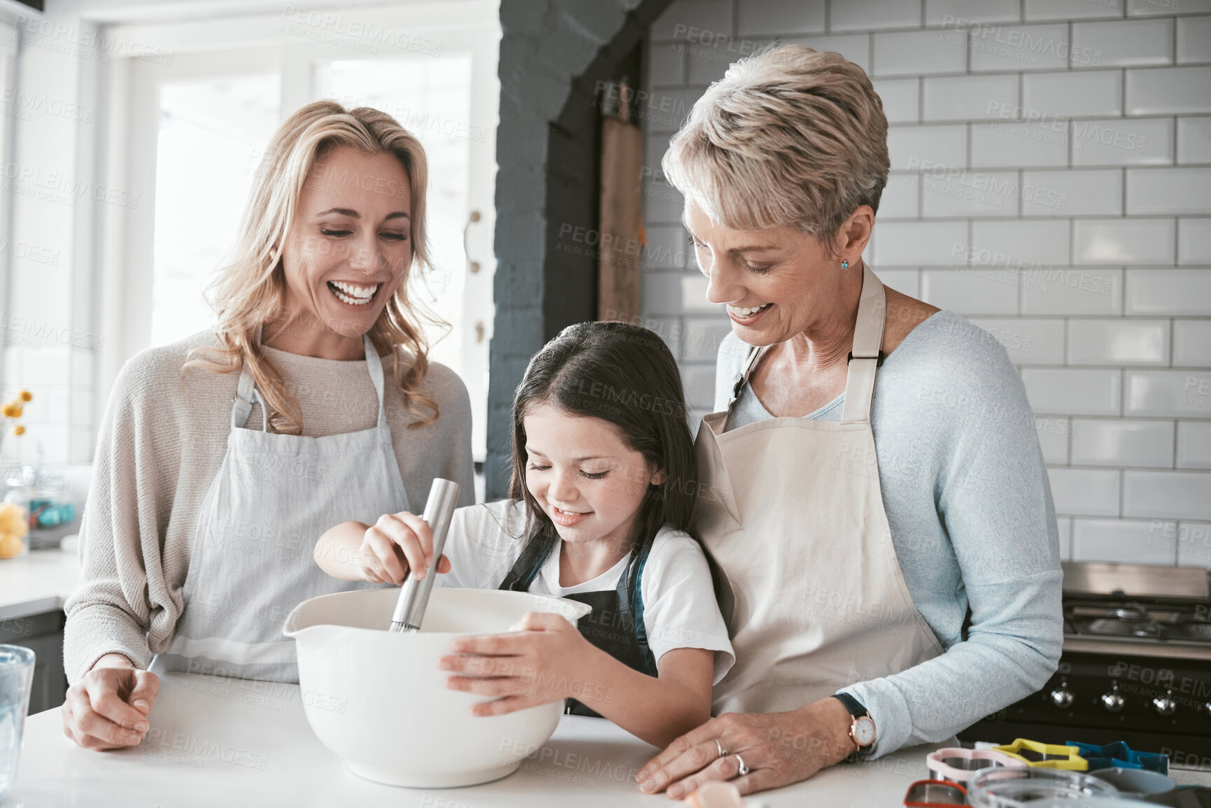Buy stock photo Family, children and baking with a mother, grandmother and girl in the kitchen of their home together. Food, kids and bake with a woman, parent and female child learning about cooking while bonding