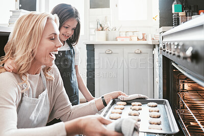 Buy stock photo Kitchen, mom and kid baking cookies in oven, excited with results working together and learning to bake family biscuit recipe. Child development, home cooking and bonding time, woman and girl in home
