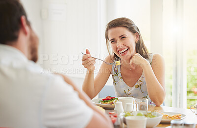 Buy stock photo Couple, eating breakfast and home with talking, happy or food for health, wellness or diet in morning. Woman, man and comic laugh together for conversation, memory or relax on vacation in dining room