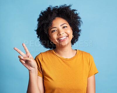 Buy stock photo Peace sign, portrait of a woman with smile and against a blue background for satisfaction. Positivity or cheerful, health wellness and face of happy female person pose against studio backdrop