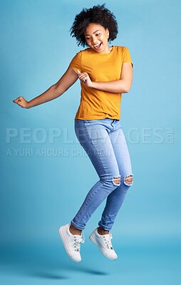 Buy stock photo Excited, happy or woman celebrate, jumping or winning with opportunity, energy or dancing. Female person, model or girl in the air, dance or excitement with victory or fun on a blue studio background