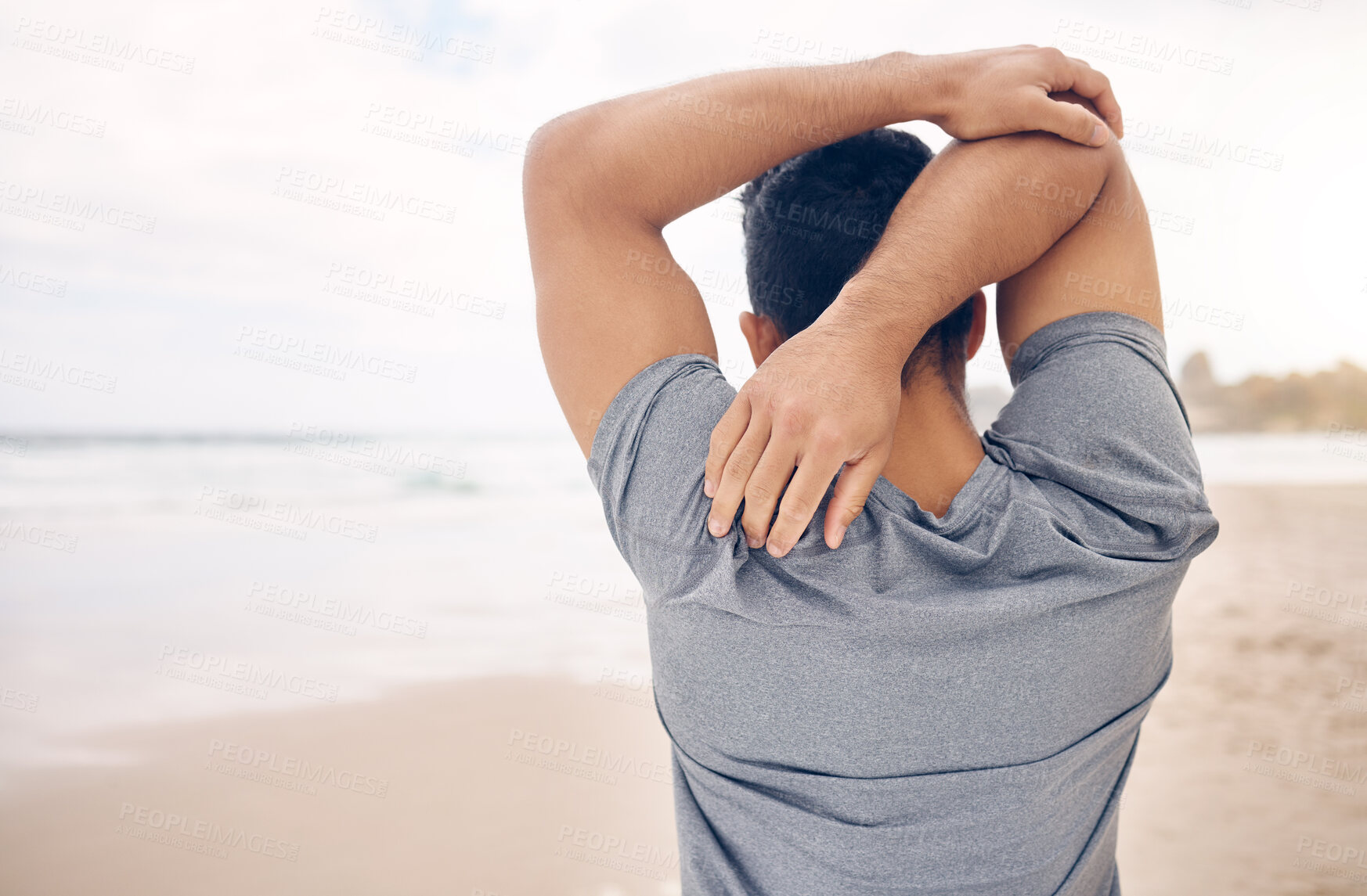 Buy stock photo Man, stretching and arms on beach, exercise and warm up for fitness, ready and workout by ocean. Male person, back and active in outdoors, challenge and prepare for performance, training and shore