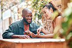 Man, woman and showing of phone at restaurant, cafe or bistro with announcement on social media. Interracial couple, people or friends with mobile app with notification, promo or offer on internet