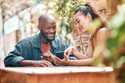 Buy stock photo Man, woman and showing of phone at restaurant, cafe or bistro with announcement on social media. Interracial couple, people or friends with mobile app with notification, promo or offer on internet