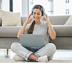 Happy, headphones and laptop with woman at home with remote work, music and living room with smile. Podcast, tech and internet with radio streaming and audio with computer by a sofa with digital job