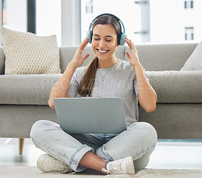 Buy stock photo Happy, headphones and laptop with woman at home with remote work, music and living room with smile. Podcast, tech and internet with radio streaming and audio with computer by a sofa with digital job