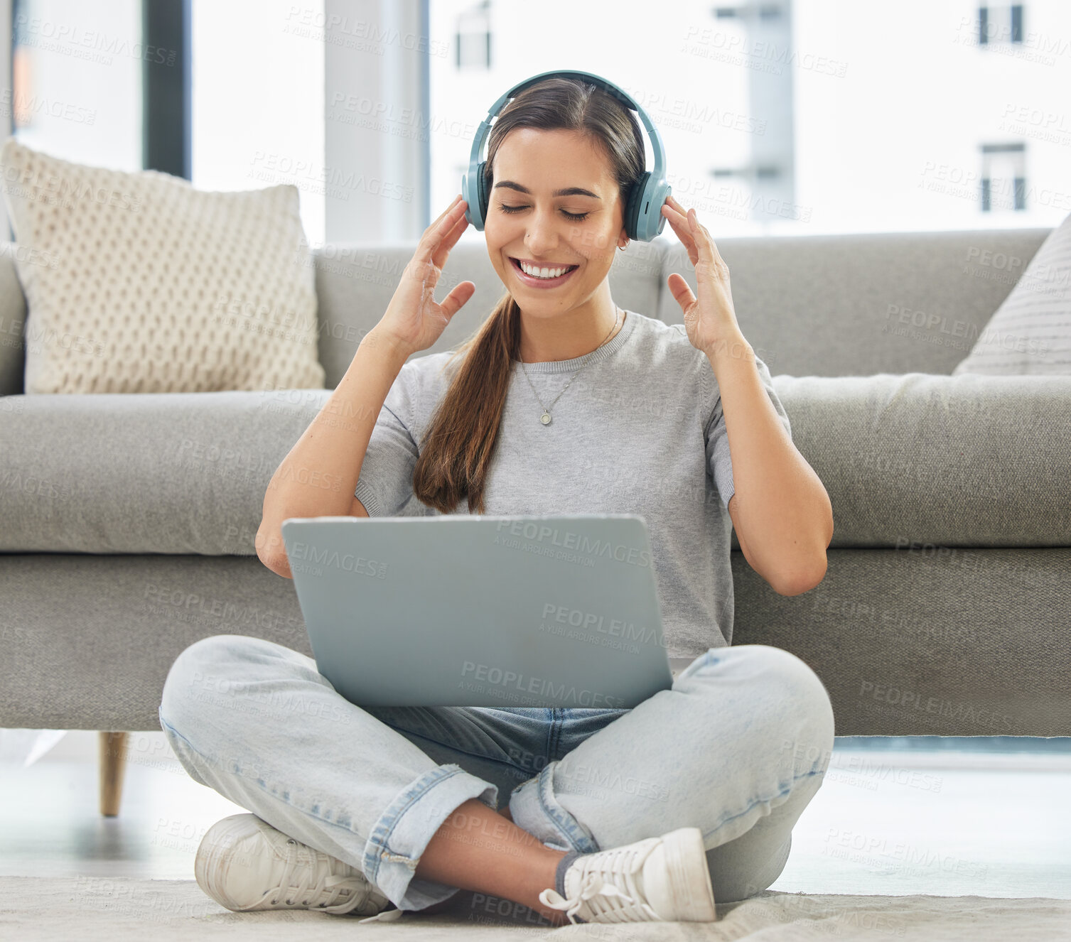 Buy stock photo Happy, headphones and laptop with woman at home with remote work, music and living room with smile. Podcast, tech and internet with radio streaming and audio with computer by a sofa with digital job