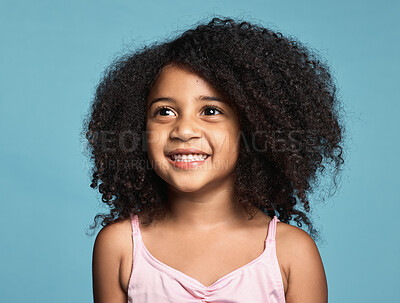 Buy stock photo Happy, smile and girl child in a studio with afro hair standing by a blue background alone. Happiness, excited and beautiful young kid from Mexico smiling with a positive, joyful and fun mindset.