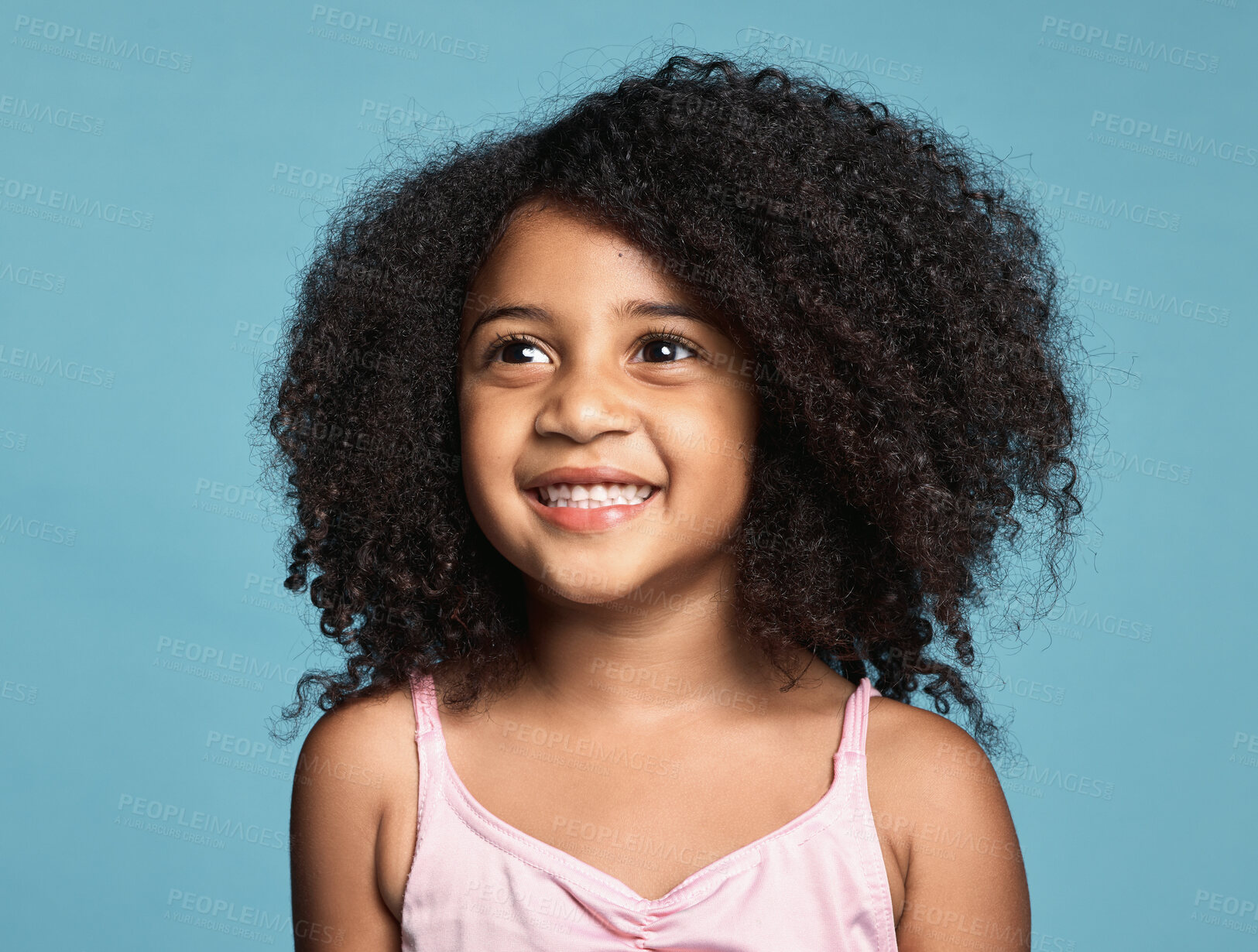 Buy stock photo Happy, smile and girl child in a studio with afro hair standing by a blue background alone. Happiness, excited and beautiful young kid from Mexico smiling with a positive, joyful and fun mindset.