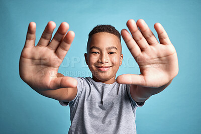 Buy stock photo Frame, photographer and hands portrait of child with satisfied smile for creative expression. Inspiration, perspective and creativity in mind of happy African boy with blue studio background.