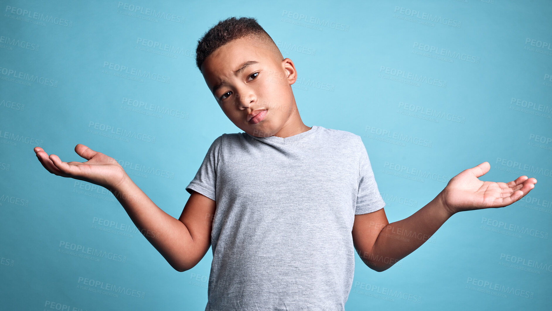 Buy stock photo Doubt, question and shrug from child with confused facial expression, don't know gesture and raised hands. Young boy, African youth and face portrait of puzzled black kid isolated on blue background