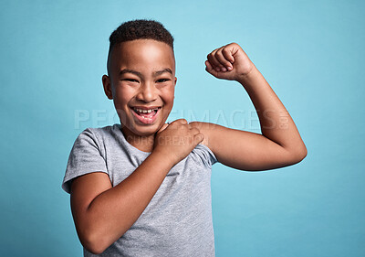 Buy stock photo Children, black boy or strong child showing strength, confidence or muscle on blue studio background. Motivation, comic or happy Brazil kid with energy, power or confident mindset excited for life.