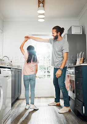 Buy stock photo Father and daughter dancing together, having family fun in the kitchen at home. Carefree, happy and loving parent teaching a little girl how to dance, practicing routine and bonding