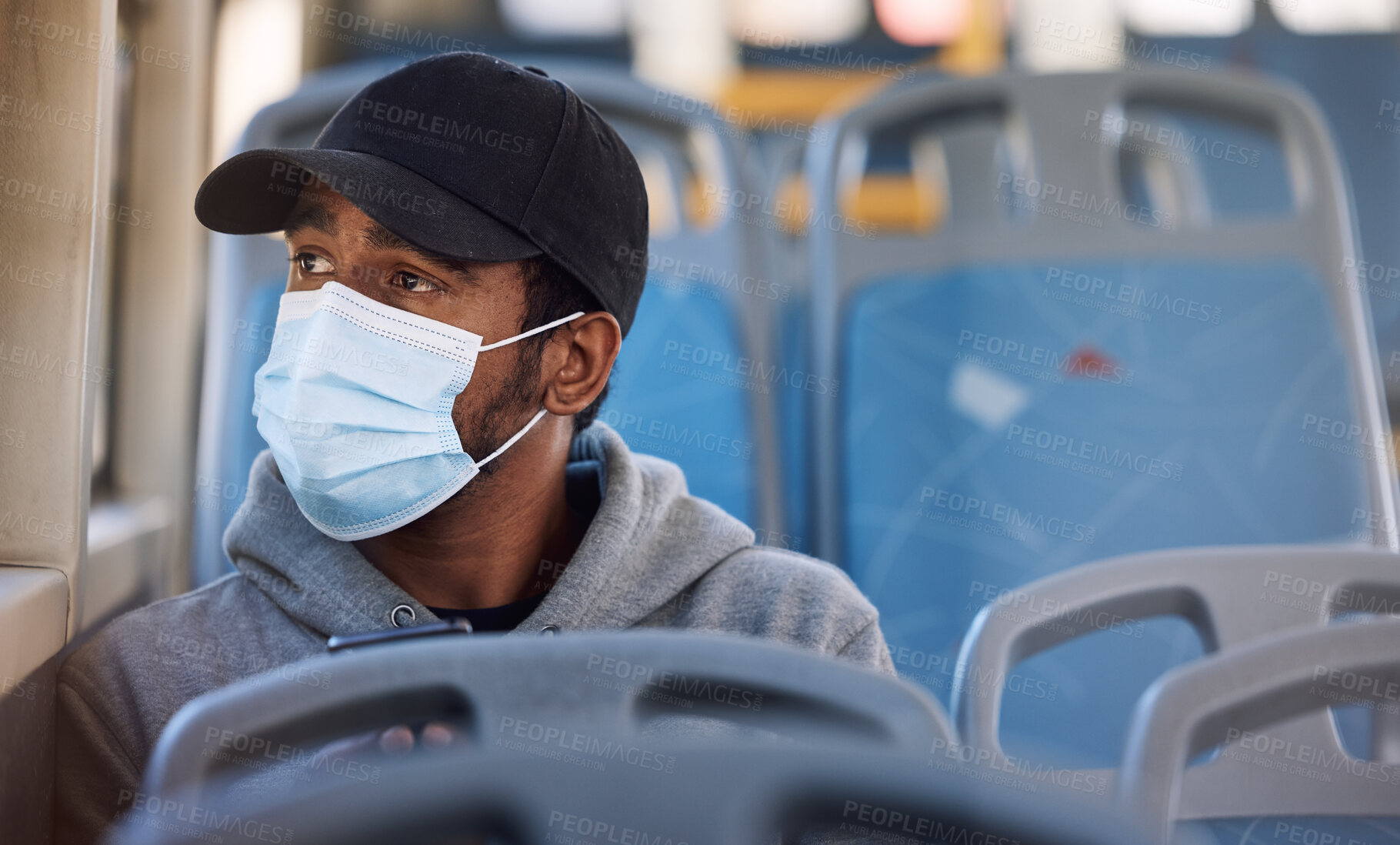 Buy stock photo Man, mask or thinking in bus in city, cold protection or window view on trip for wellness. Young person, cap or medical cover on mouth for flu virus, transport safety or healthcare rules on vehicle