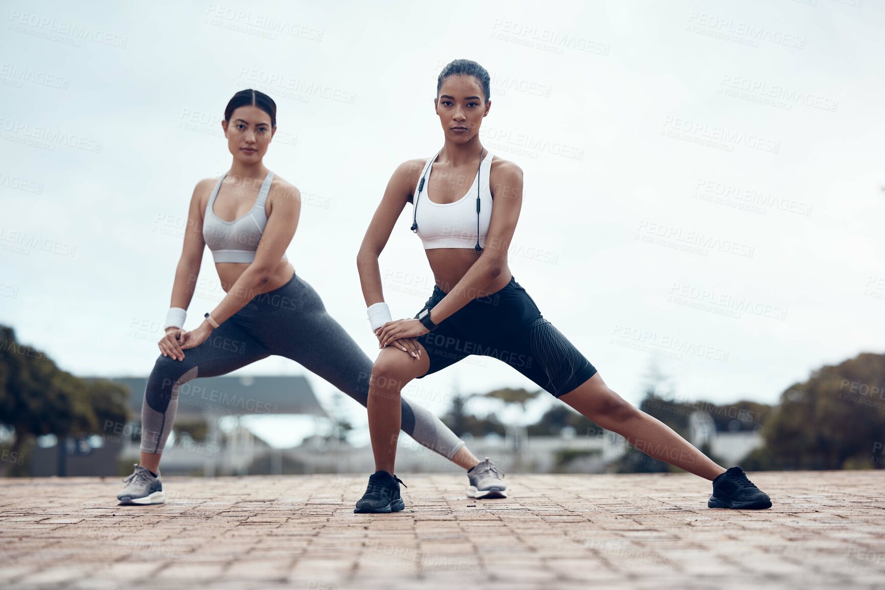 Buy stock photo Exercise, women and stretching for wellness, outdoor and training for fitness, health and in sportswear. Female, girl and practice for workout, warm up and outside being focus, healthy and for cardio