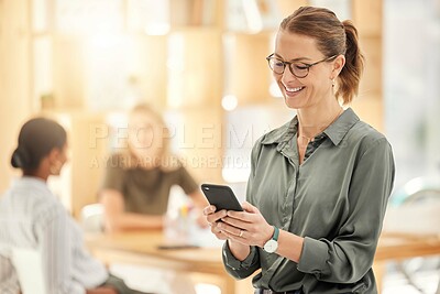 Buy stock photo Business woman, phone and technology of a happy employee reading a text or social media post. Working web design worker in a office women team meeting looking at mobile screen content with a smile 