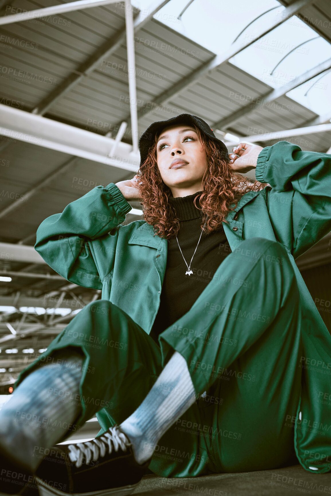 Buy stock photo Fashion, green designer clothes and black woman relax on floor with gen z streetwear, hip hop style or rap aesthetic. Creative brand apparel, edgy outfit and luxury fashion model with cool attitude
