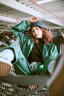 Buy stock photo Fashion, gen z and woman in a shopping cart with stylish clothes and cool look in city street style. Portrait of a model girl and teenager from Spain in a garage parking lot with an urban outfit