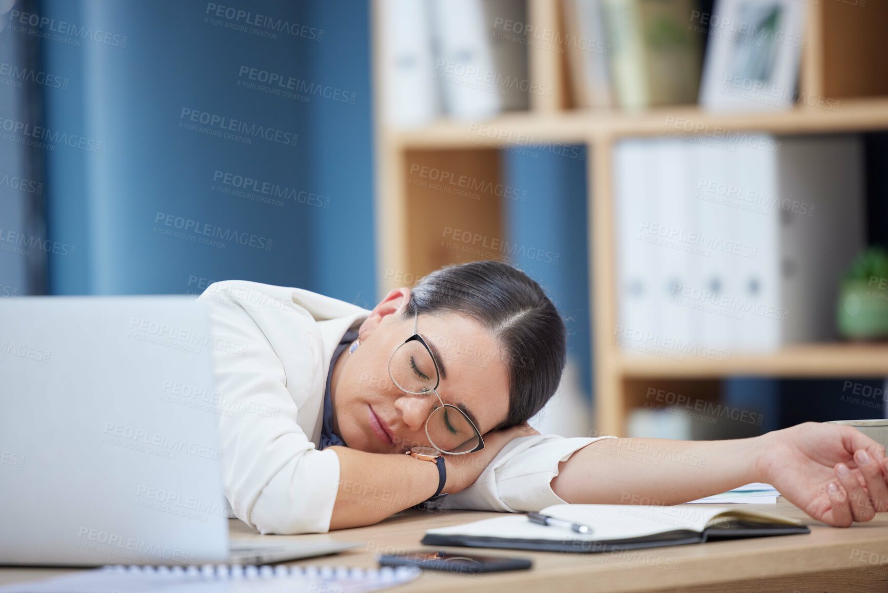 Buy stock photo Burnout, sleeping and tired business woman in office after working overtime or overwork. Rest, relax and exhausted sleepy female employee taking nap by table after all night work on project deadline
