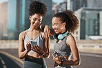 Running, phone and social media with woman friends tracking their sports progress on a mobile app in the city. Fitness, exercise and 5g mobile date with a female athlete and friend in an urban town