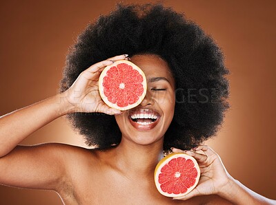 Buy stock photo Black woman, diet and vitamin C for facial beauty, hair care and skin health in studio background. Face, smile or relax luxury wellness or cosmetics, self care and skincare eye treatment or nutrition