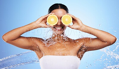 Buy stock photo Black woman, water splash and orange skincare for natural beauty routine, organic skin health and vitamin c detox treatment. Happy smile, facial cleaning spa and advertising mockup on blue background