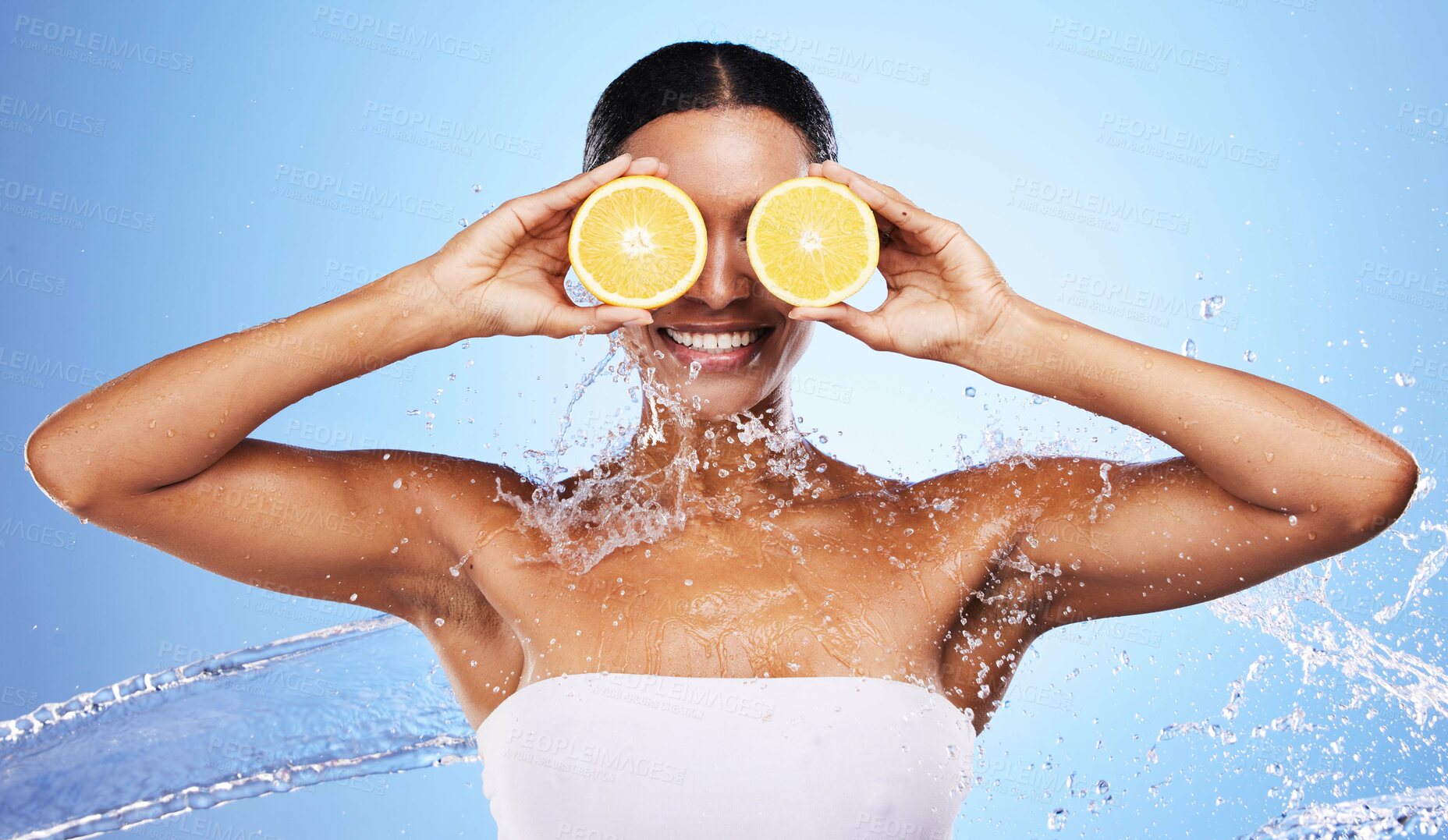 Buy stock photo Black woman, water splash and orange skincare for natural beauty routine, organic skin health and vitamin c detox treatment. Happy smile, facial cleaning spa and advertising mockup on blue background