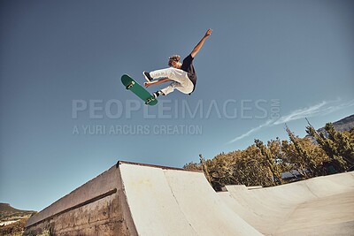 Buy stock photo Sports, skateboarding and skater in air at park doing tricks, skating and having fun in urban town. Fitness, freedom and man do action skills, jumping and cool movement for sport, hobby and exercise
