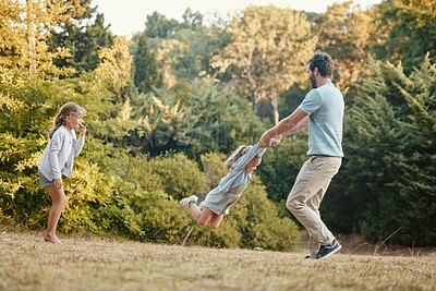 Buy stock photo Nature, park and father playing with girls while on outdoor adventure, journey or exploring. Happiness, freedom and dad having fun with children in green garden while on weekend getaway or vacation.