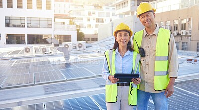 Buy stock photo Solar energy, building and engineer team portrait with tablet, smile or rooftop for sustainability. Man, woman and solar panel in city for renewable energy on roof with mobile tech, teamwork and goal