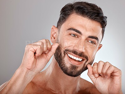 Buy stock photo Floss, teeth whitening and happy man with healthy dental lifestyle, wellness or skincare on studio background. Male model face, tooth flossing and cleaning mouth of facial smile, fresh breath or body