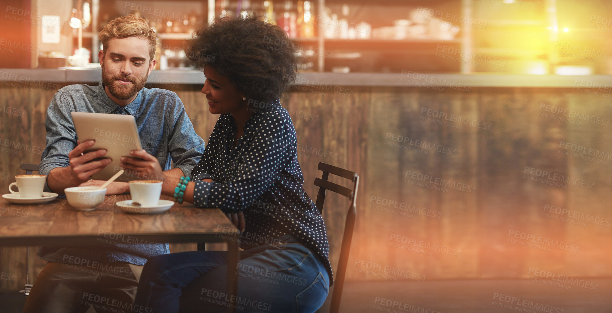 Buy stock photo Couple, coffee shop and tablet with free wifi on a date for internet, communication and online menu. Interracial man and woman with mobile app in cafe or restaurant talking at table mockup space