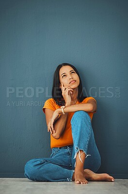 Buy stock photo Woman on ground, thinking and decision for opportunity, ideas and girl daydreaming on blue studio background. Female with imagination, lady on floor and wondering with focus, mindset and thoughts