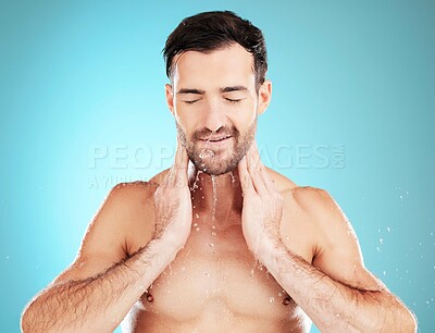 Buy stock photo Skincare, man washing face and water, morning cleaning treatment isolated on blue background. Facial hygiene, splash and male model grooming for health, wellness and clean skin care beauty in studio.