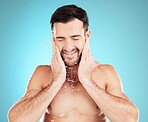 Water, skincare and man with cleaning beard, morning beauty treatment isolated on blue background. Facial hygiene, splash and male model grooming face for health, wellness and spa skin care in studio