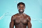 Water splash, studio and black man isolated on blue background with face cleaning, body and skincare beauty. Strong, muscle and happy model or person in shower aesthetic, wash and dermatology hygiene