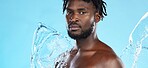 Banner, shower and portrait of a black man with a water splash isolated on a blue background. Cleaning, beauty and African model for grooming treatment, hygiene and care of body on a studio backdrop