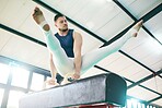 Fitness, gymnastics and man on a balance beam for training, cardio and strength at gym. Athletic, male and acrobat practice speed, control and sport routine for muscle, power or endurance performance