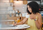 Cafe, freelancer and woman writing notes for a freelance project while drinking a cup of espresso. Technology, notebook and female from Mexico planning business report with a cappucino in coffee shop