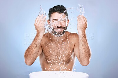 Buy stock photo Water splash, skin care and portrait of man for clean spa facial for beauty hygiene and dermatology. Aesthetic model person washing face on blue background for cosmetics, body and detox cleaning
