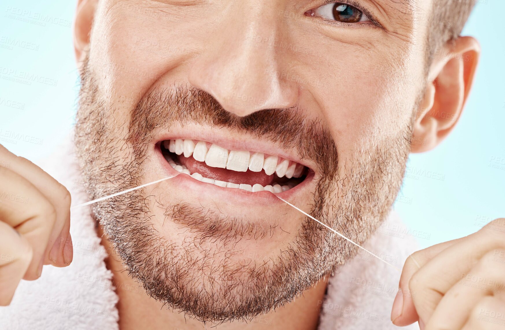 Buy stock photo Dental care, health and man flossing teeth in studio for oral wellness or tooth grooming. Dentistry, healthy and closeup of male model doing fresh, clean and natural mouth routine by white background