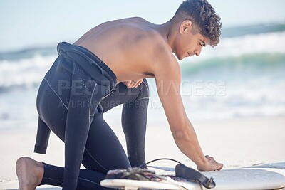 Buy stock photo Fitness, beach and surfboard waxing of a man surfer ready for exercise, sport and training outdoor. Waves, ocean and summer workout of a young person with sport equipment in nature for surfing 