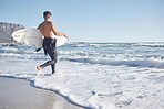 Surfing, man and walking in waves, sea and ocean for summer, freedom and blue sky in Cape Town, South Africa. Surfer guy, board and swimming in water, beach and relax on holiday, travel and adventure