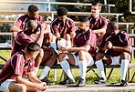 Sports, fitness and rugby team with ball ready for exercise, training and workout for field practice. Depression, teamwork and sad athletes on stadium stand after match, game and competition loss