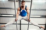 Gymnast man, bars and training with balance, strong body and focus for sports, vision and professional career. Gymnastics, athlete and exercise with muscle development, workout and low angle at gym